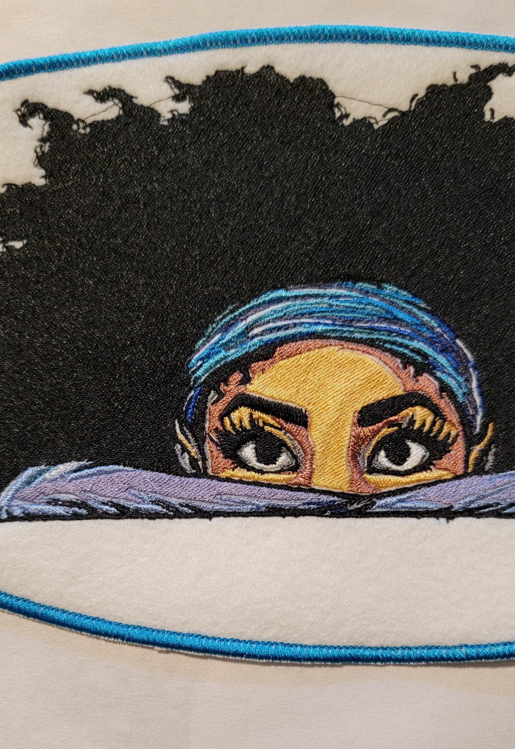 Playful Embroidered Patch features a whimsical young lady peeking over the top of her folded arms, ready for adventure!