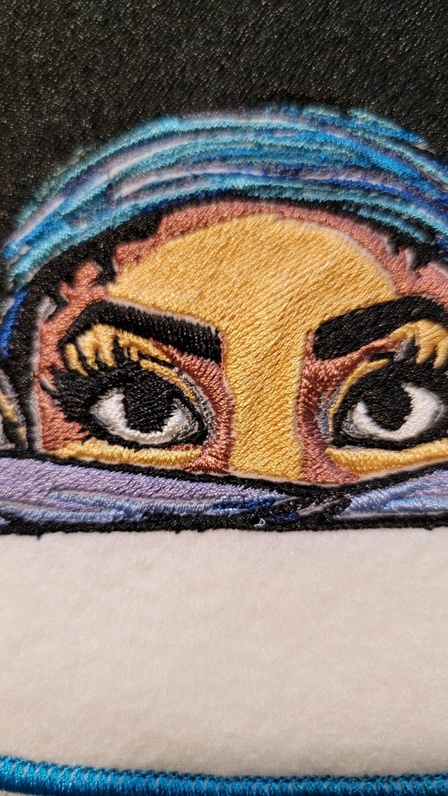 Playful Embroidered Patch features a whimsical young lady peeking over the top of her folded arms, ready for adventure!